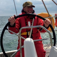 Dr. Peter Jones steering a ship